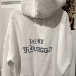 Princess Polly white hoodie with love yourself in purple letters on the back.